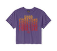 Purple t-shirt with 'Good Vibrations' text design on a white background